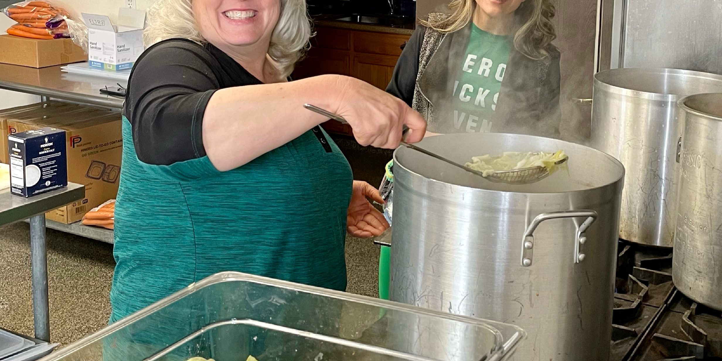 3173 – LtoR Chris Hebard-Summers and Ashley Summers cooking Soroptimist St. Patrick’s Dinner